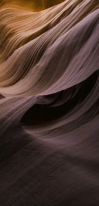 Sandstone formations with flowing textures and warm purple hues.