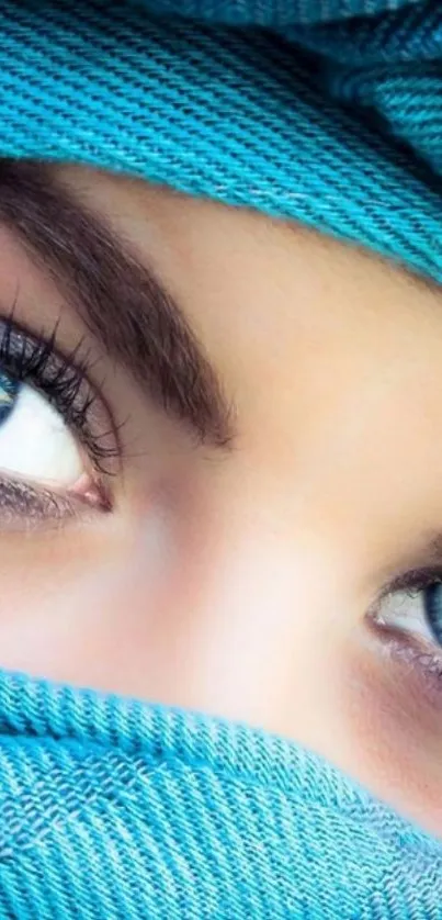 Close-up of captivating blue eyes with turquoise scarf mobile wallpaper.