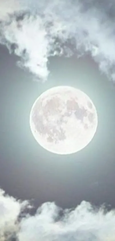 Full moon surrounded by soft clouds in a serene night sky.