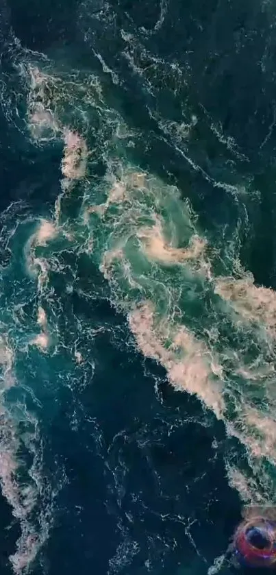 Aerial view of deep blue ocean waves with white swirling patterns.