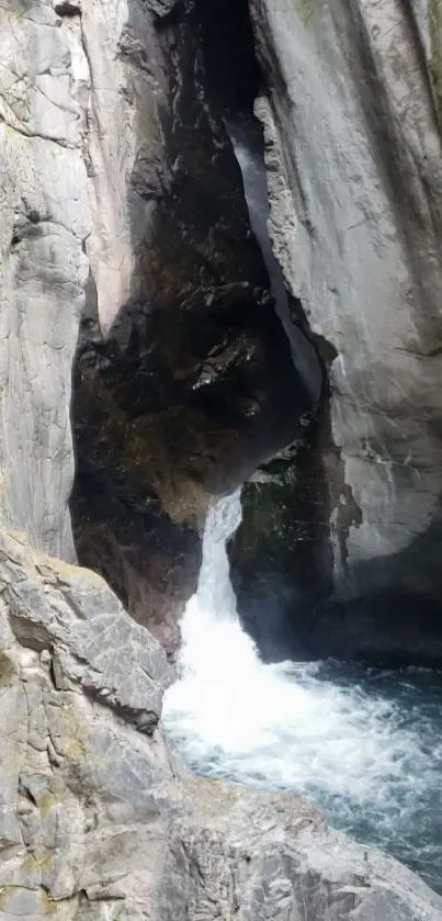 Rocky waterfall in a gorge with flowing water.