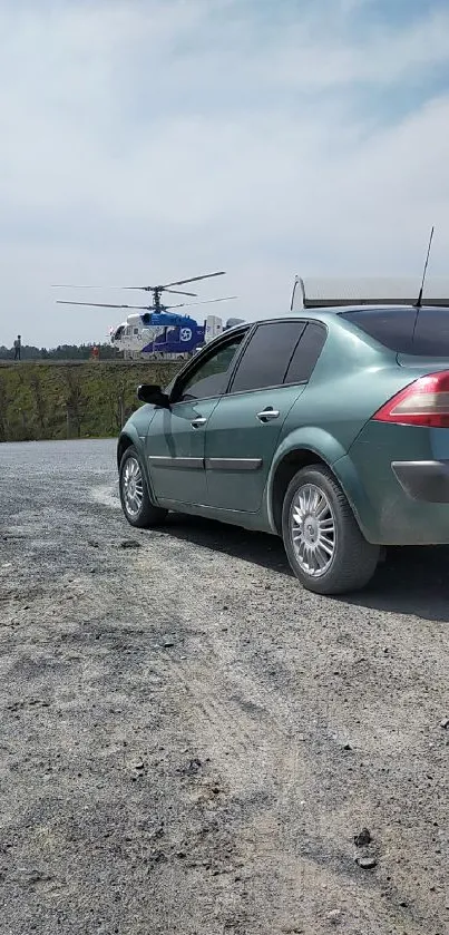 Green car and helicopter on gravel road wallpaper.