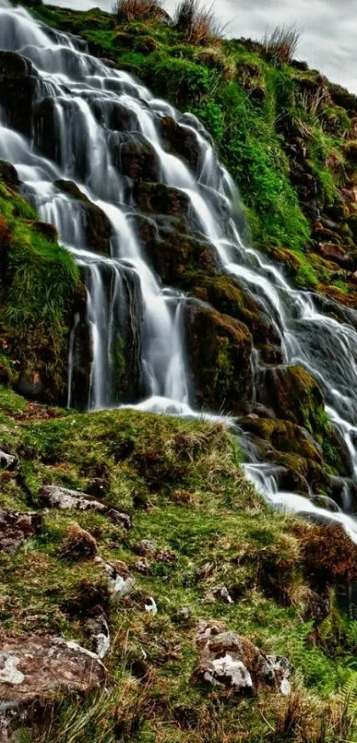 Cascading waterfall amidst lush greenery in nature.