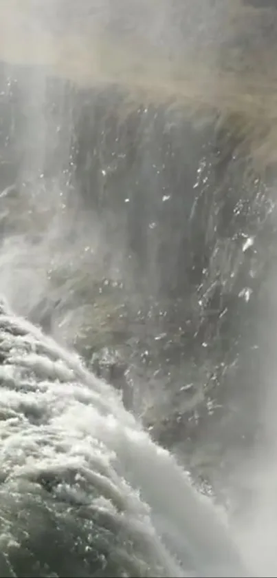 A cascading waterfall flows down a rocky cliff in a serene, natural landscape.