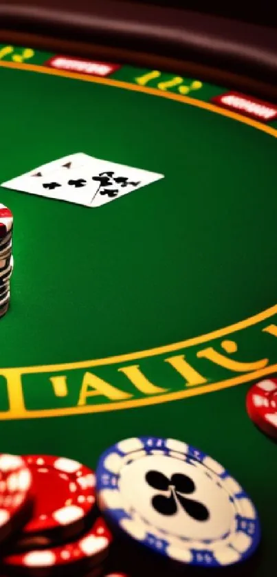 Casino table with poker chips and playing cards in vibrant green setting.