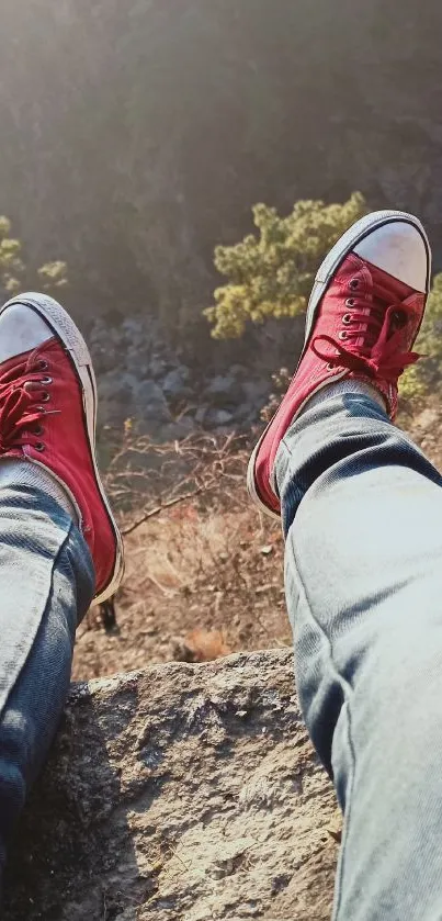 Red sneakers overlooking a cliff edge with blue jeans.