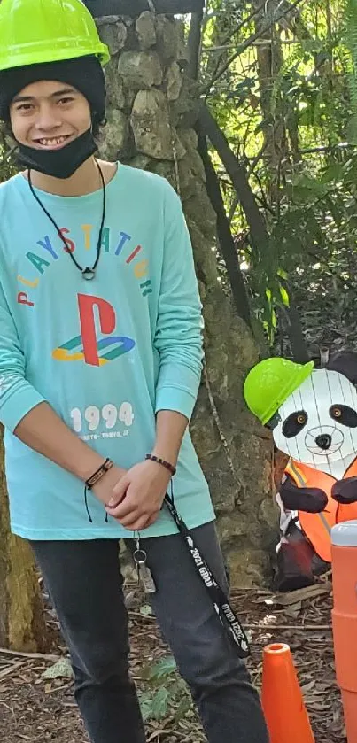 Person and panda statue with helmets in forest.