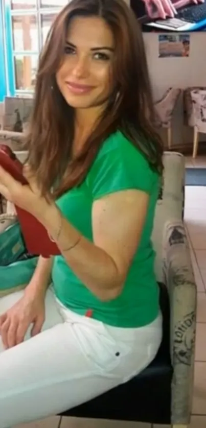 Smiling woman in casual cafe setting with colorful decor.