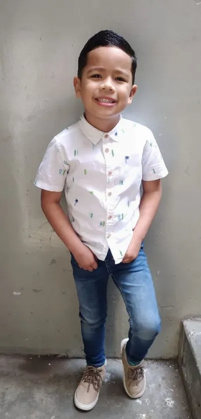 Young boy in casual jeans and a white shirt, standing on stairs.