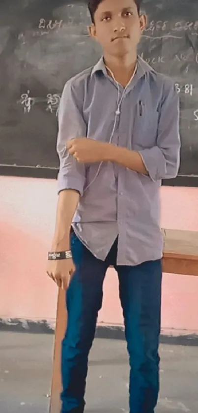 Person standing in casual attire by a chalkboard.