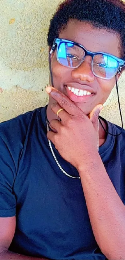 Young man in glasses smiling, casual look.