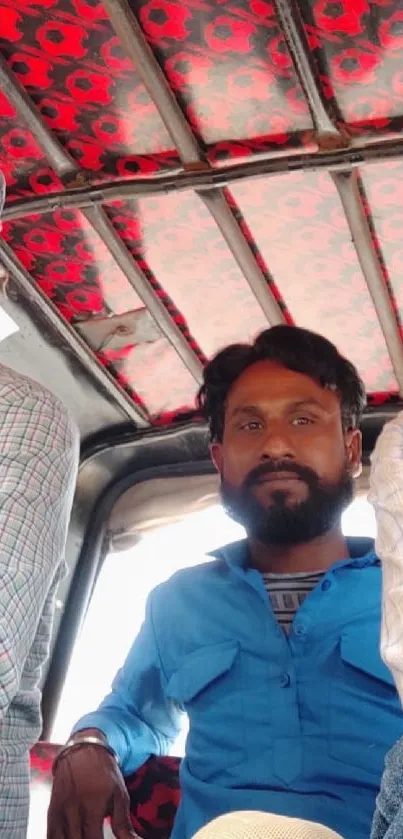 Three men in tuk tuk, casual setting.