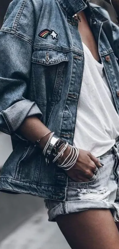 Woman in denim jacket and shorts, stylish look.