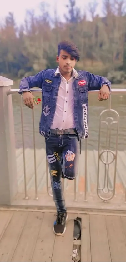 Casual young man in denim by a lake.