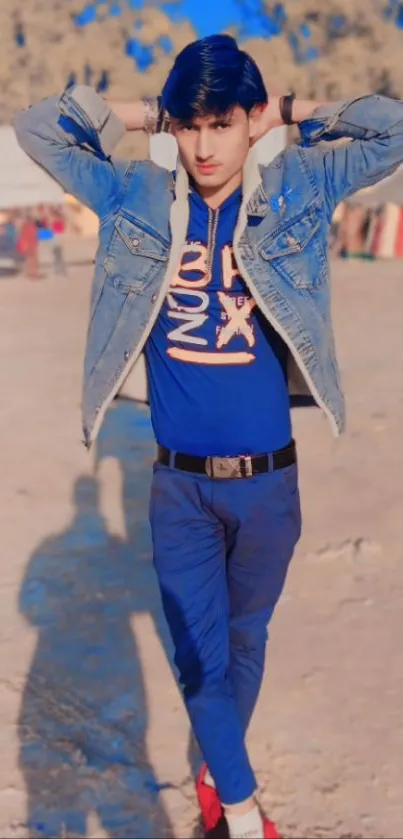 Person in denim jacket posing outdoors.