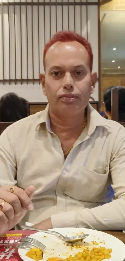 Man in restaurant with casual dining setup.