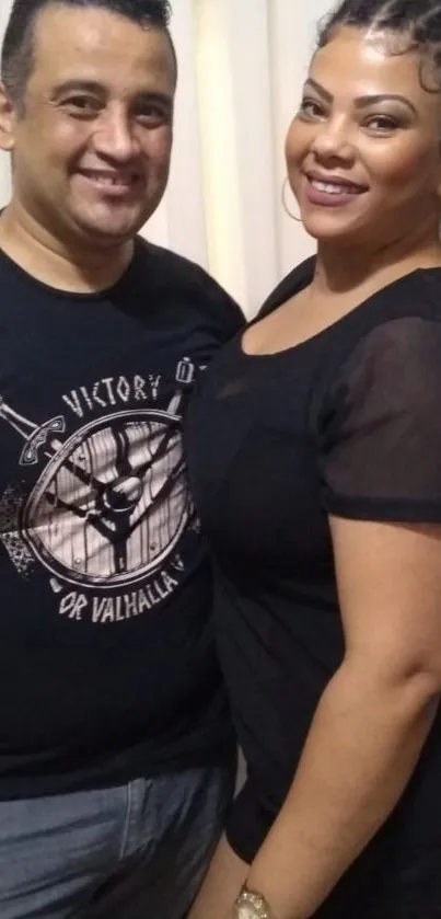 Casual duo smiling together, wearing black t-shirts.