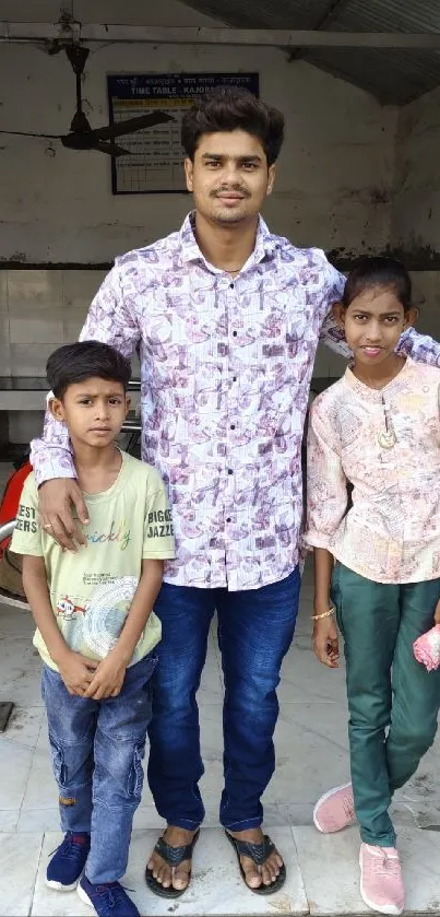 A man with two children posing happily indoors.