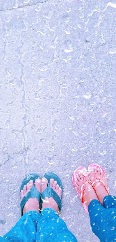 Top-down view of feet in colorful sandals on a sunlit pavement.