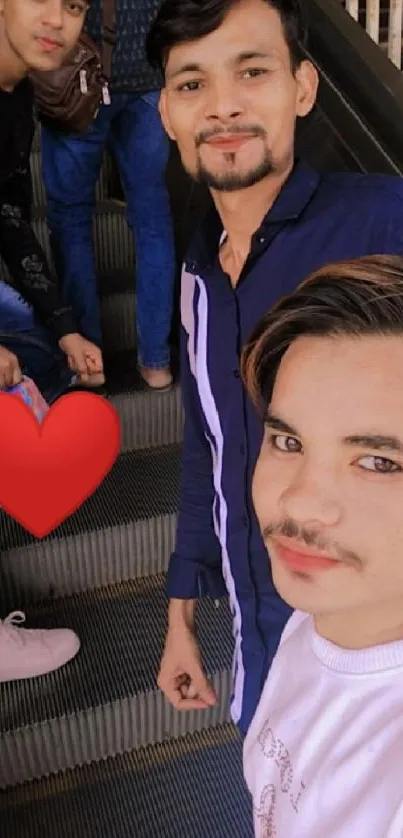 Three friends on an escalator with a red heart symbol.