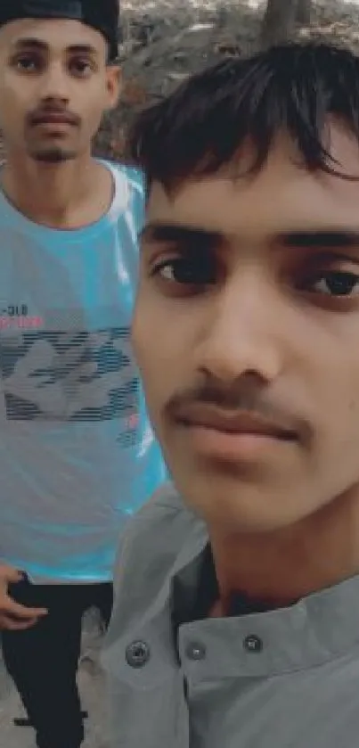 Two friends taking a casual outdoor selfie.