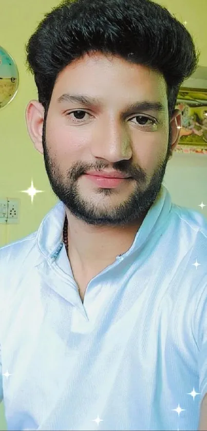 Casual indoor portrait of a smiling man in white shirt.