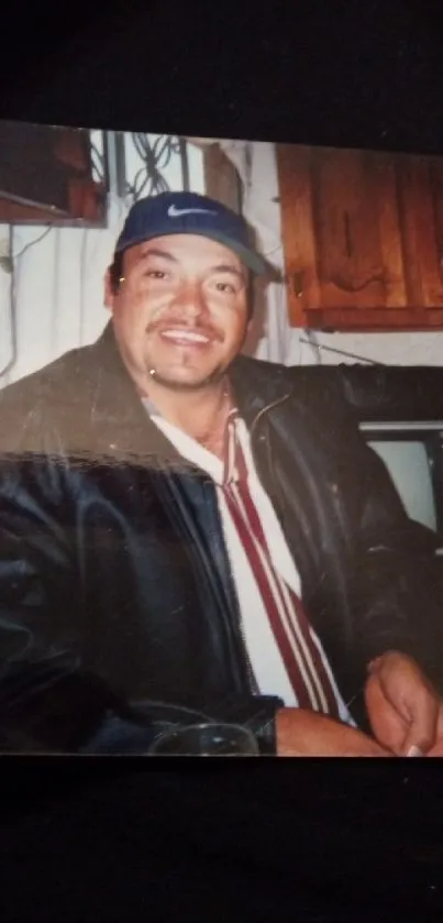 Person smiling casually in kitchen setting.