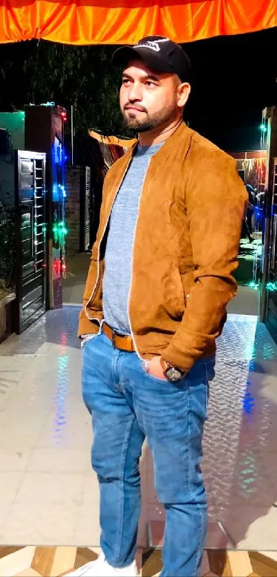 Man in casual outfit outdoors at night.