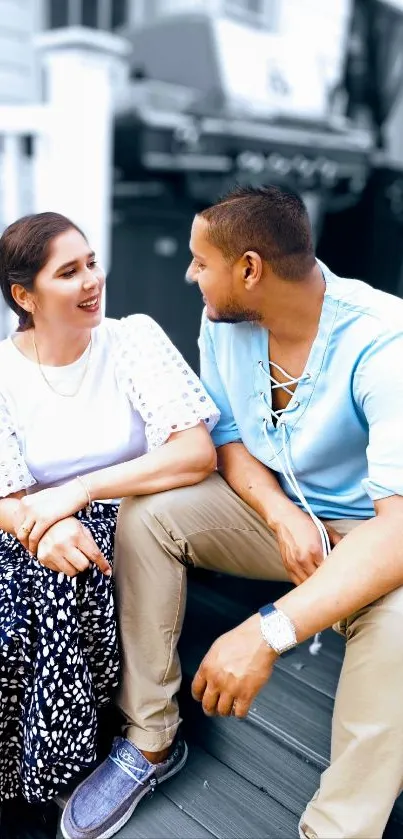 Couple enjoying a relaxed outdoor moment with a light blue theme.