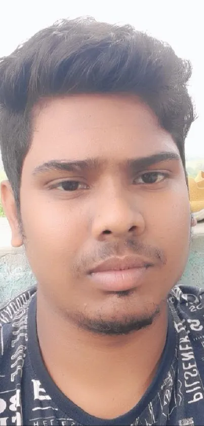 Portrait of a young man outdoors with a relaxed style.