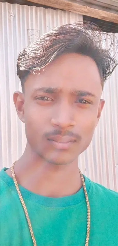 Casual portrait of young man outdoors with green shirt and stylish hair.