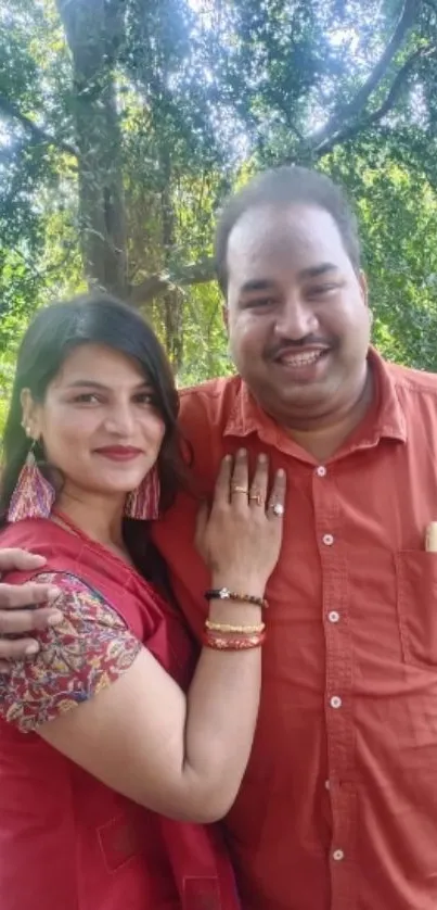 Smiling couple in vibrant outfits outdoors.