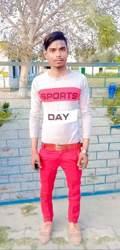 Young man in red pants with nature backdrop.