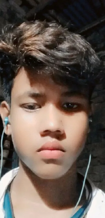 Young man wearing earphones in a casual portrait setting.