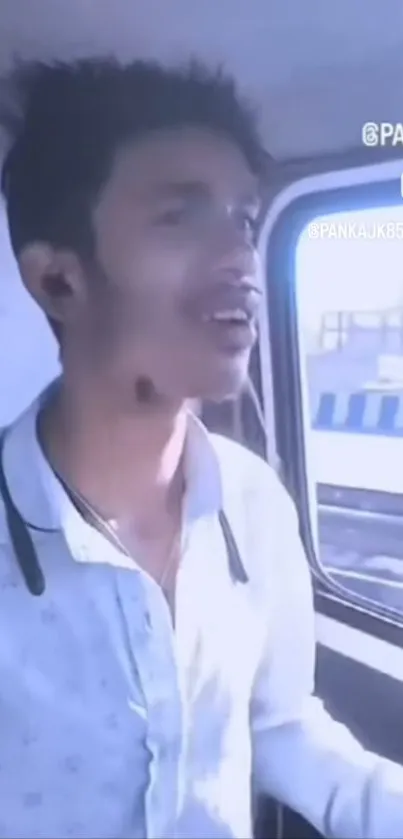 Young man standing in a moving vehicle