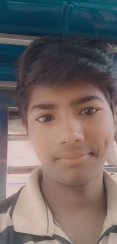 Portrait of a young person with a striped shirt in a casual setting.