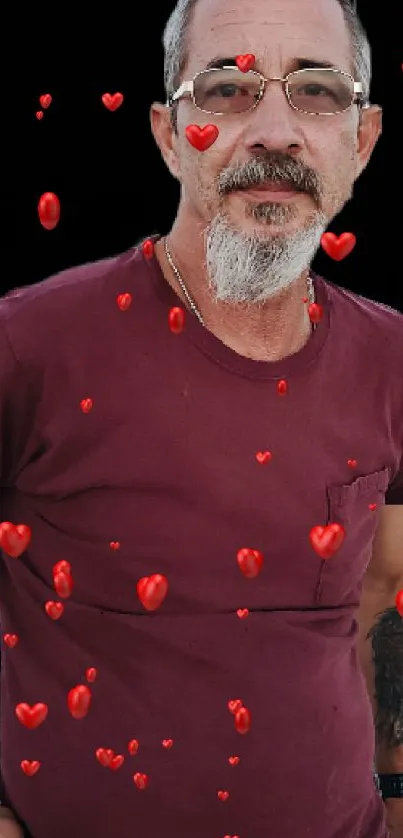 Portrait of a man in a burgundy shirt outdoors.