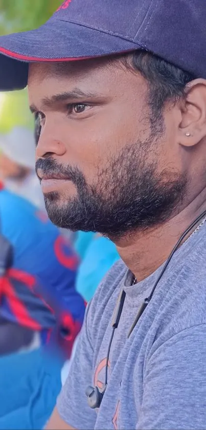 Portrait of a man in casual attire, with a blue background