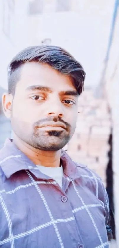 Casual portrait of a young man outdoors with a stylish, modern look.