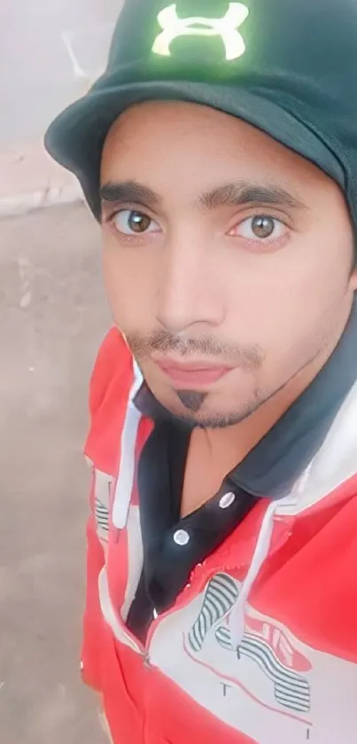 Person in a red jacket with a black cap, vibrant mobile wallpaper.
