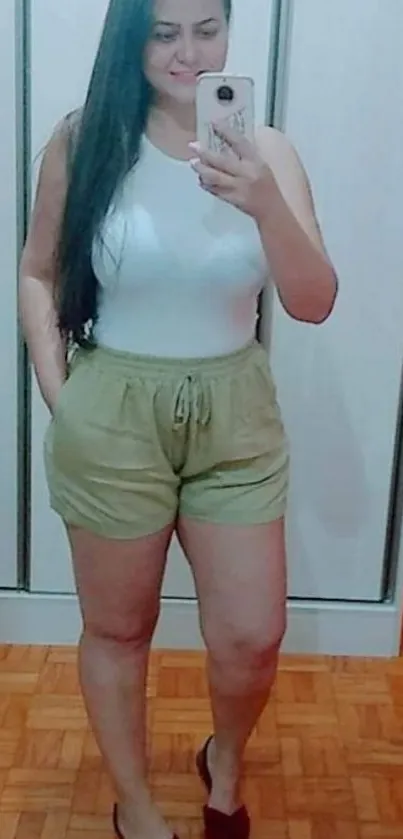 Mirror selfie with casual outfit in stylish room.