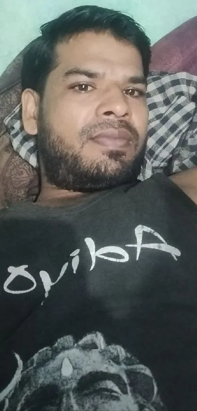 Man lying down in casual, relaxed pose.