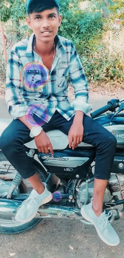 Person sitting on a motorcycle outdoors in casual attire.