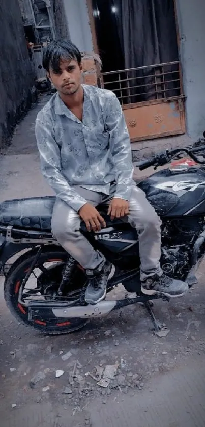 Man sitting on a motorcycle in an urban street.