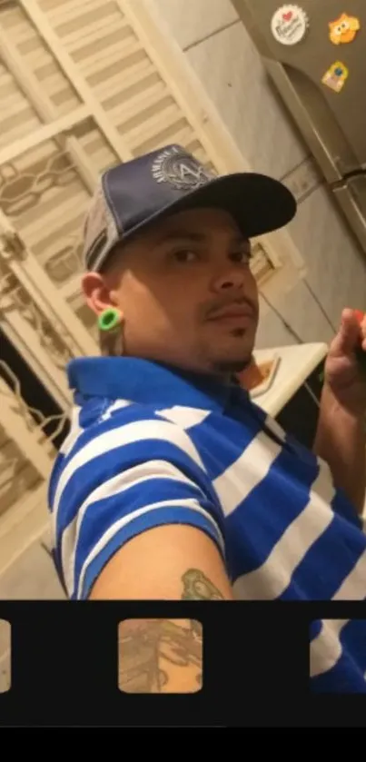 Casual selfie in blue striped shirt in a kitchen.