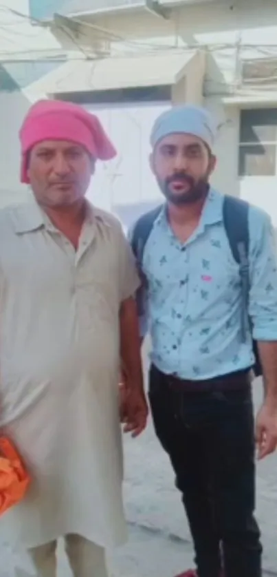 Two men in colorful headwear on street, casual style.