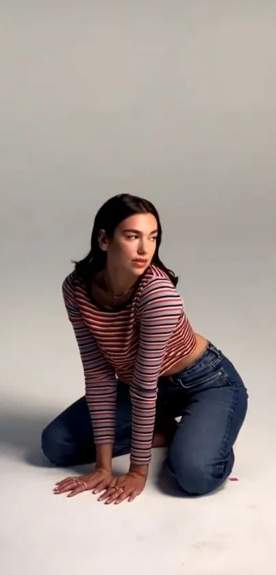 Casual fashion wallpaper with a woman in a striped top and jeans.