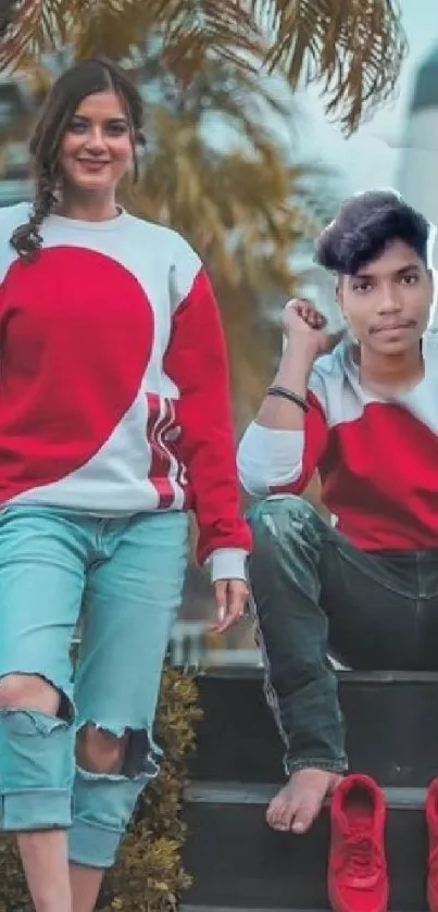 Trendy duo wearing red and denim in a fashionable pose.