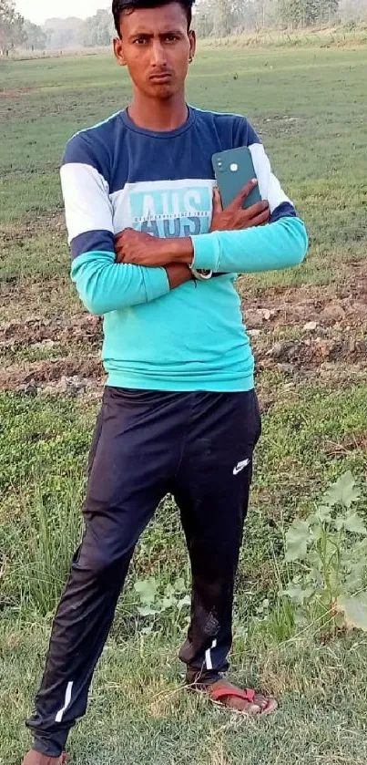 Man in casual attire with nature background.