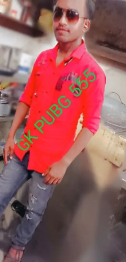 Stylish man in red shirt standing in modern kitchen background.